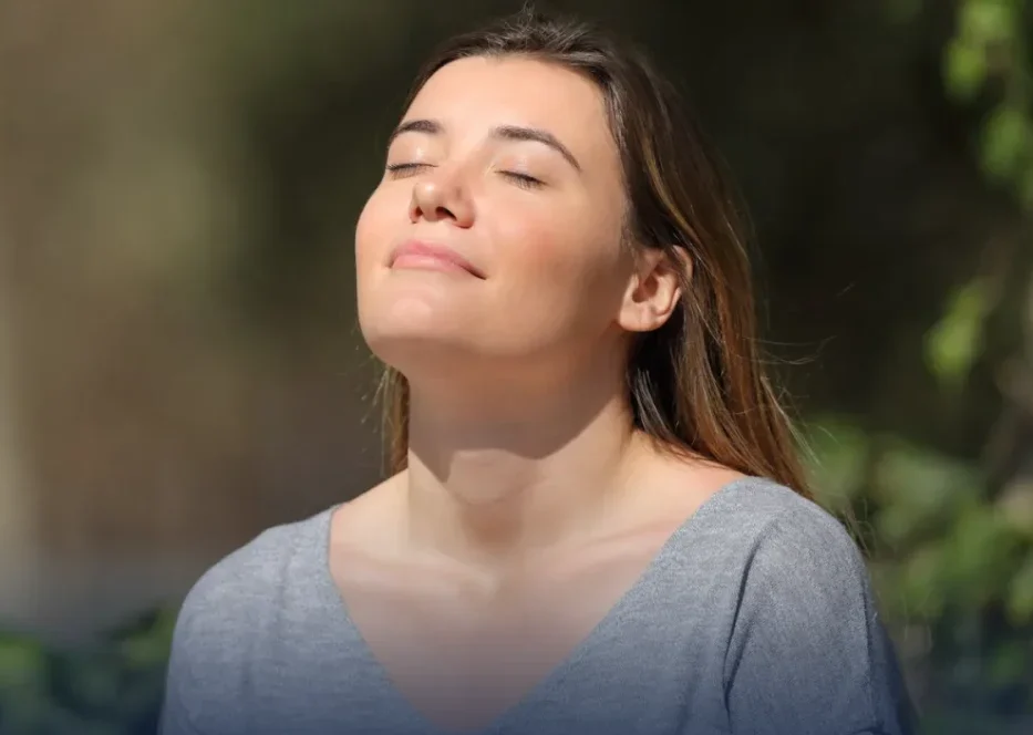Woman looking upward outdoors in natural sunlight